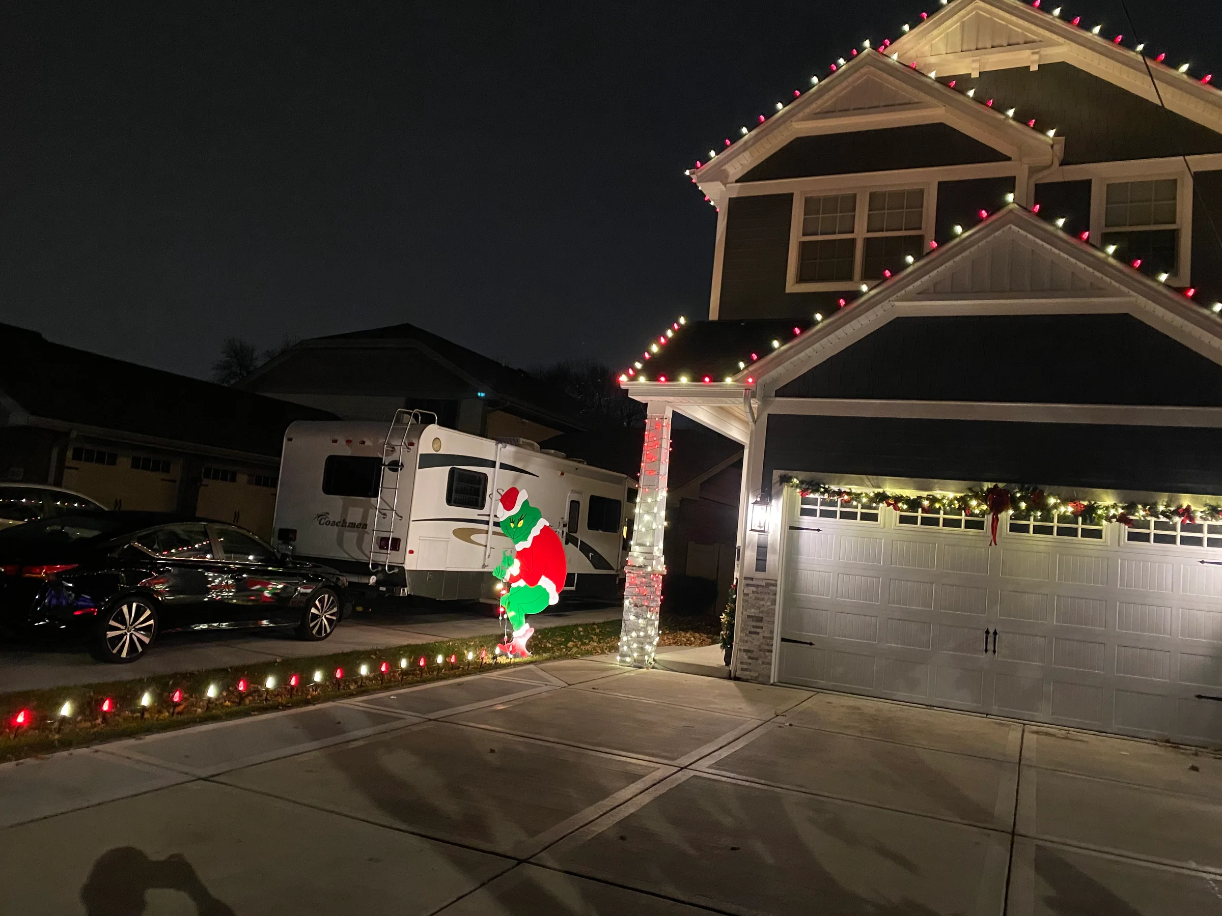 Holiday lights tracing the roofline of a Michigan home
