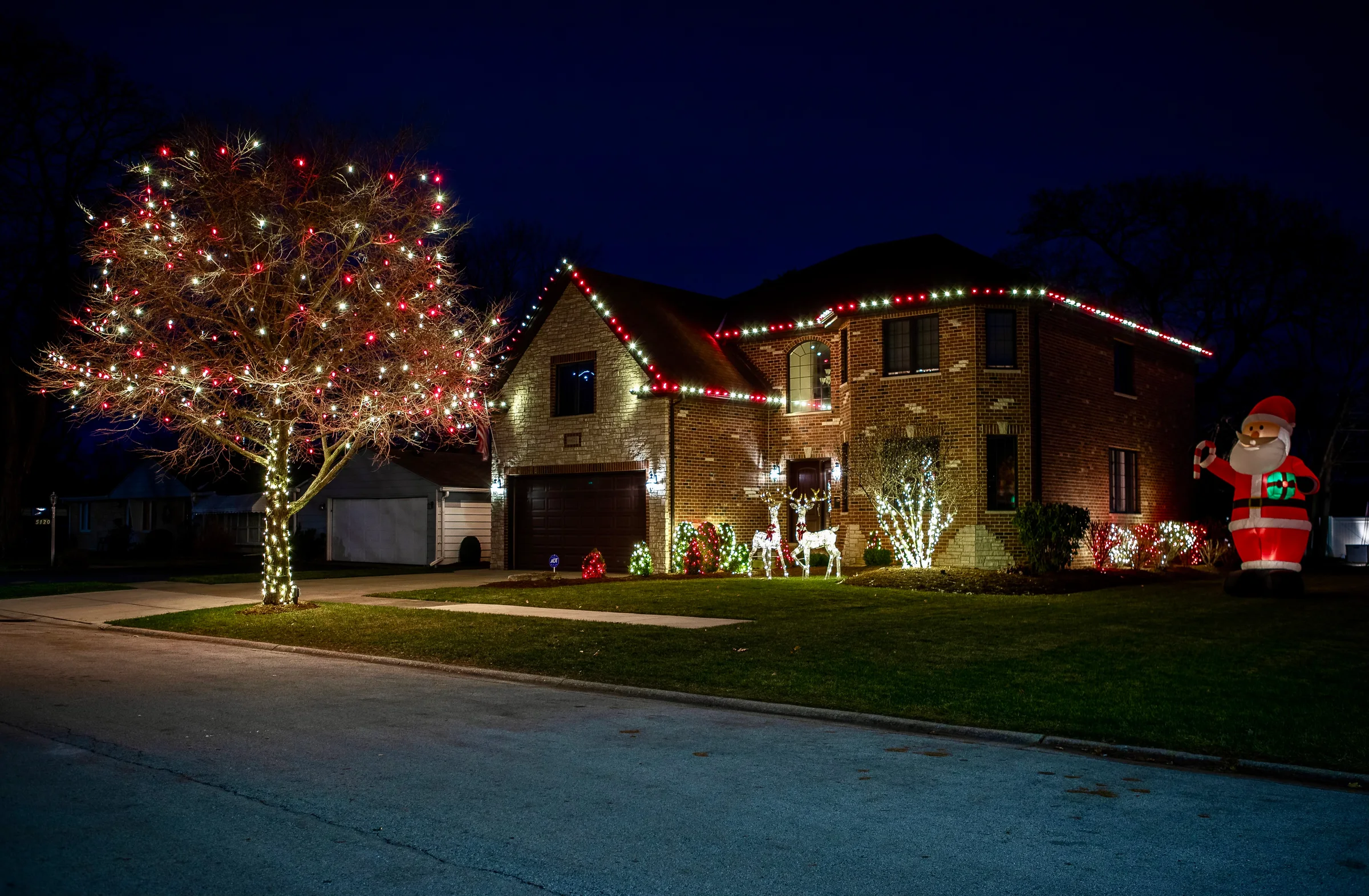 Red and warm white display with roof, tree, and yard décor