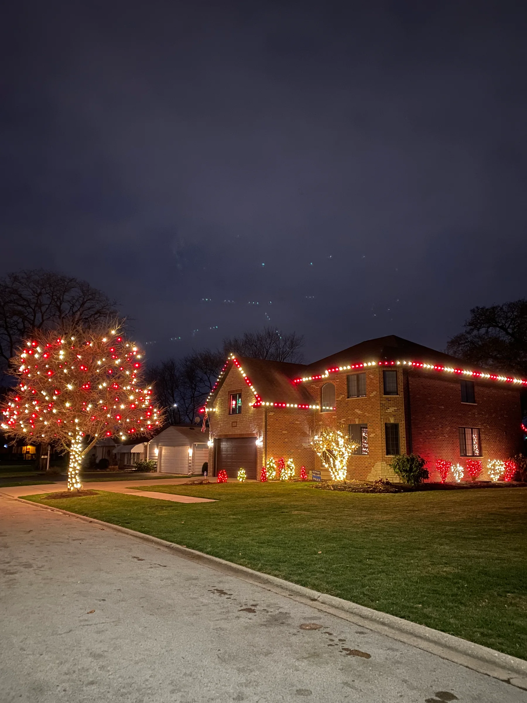 Red and white architectural lighting with matching landscaped accents