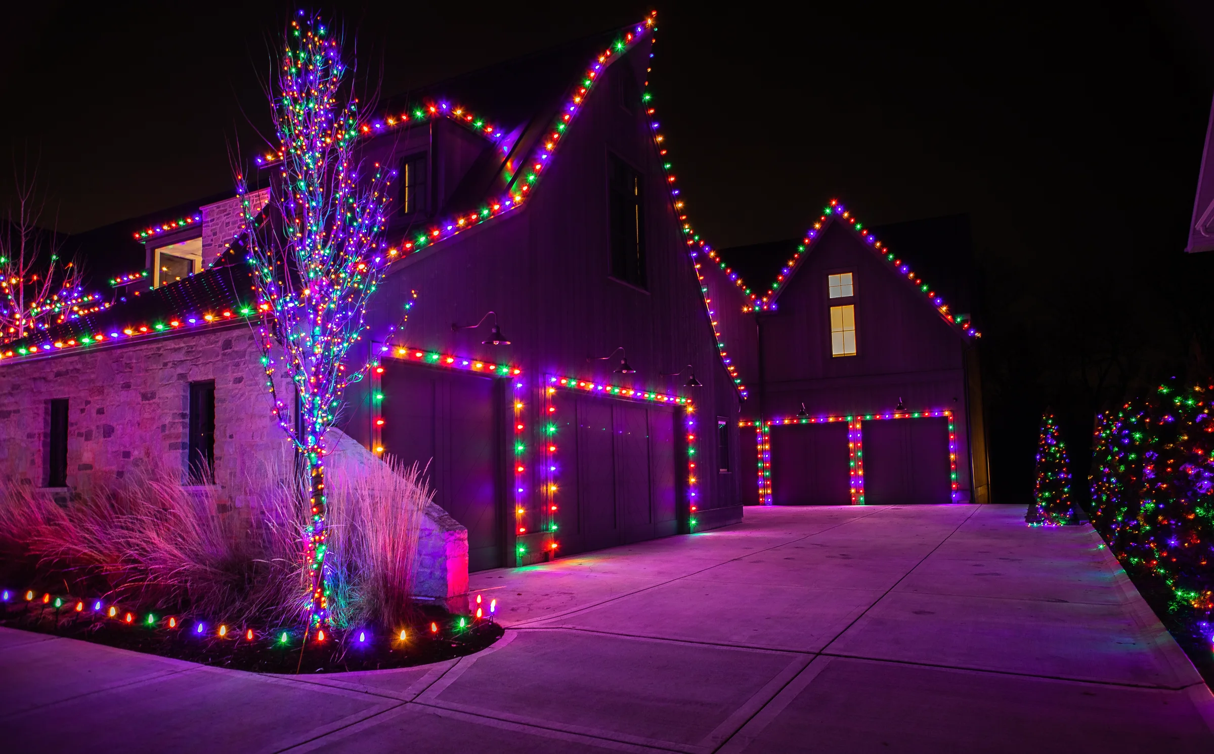 Vivid multicolor lighting across a multi-building residential property
